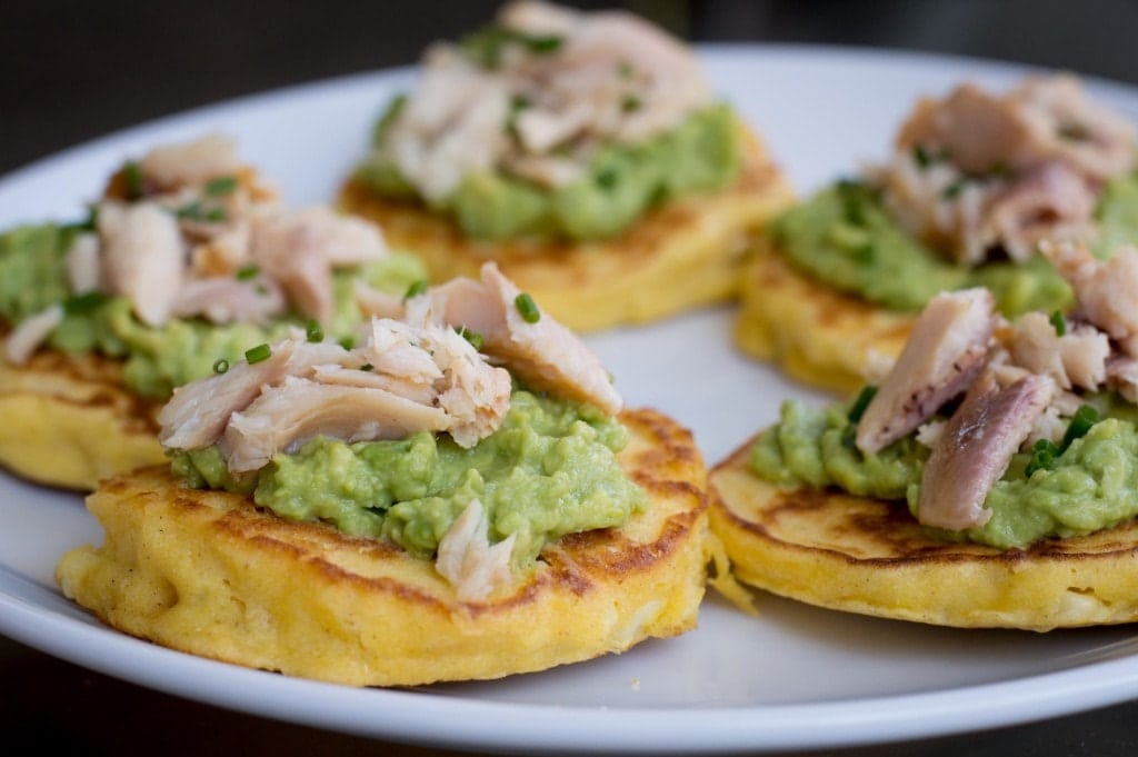 Corn cakes with avocado and smoked trout